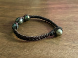 Bracelet quatre perles de Tahiti sur cuir tressé